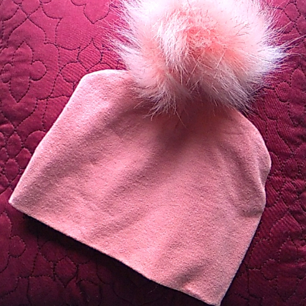 Pink hat with big fur pom pom